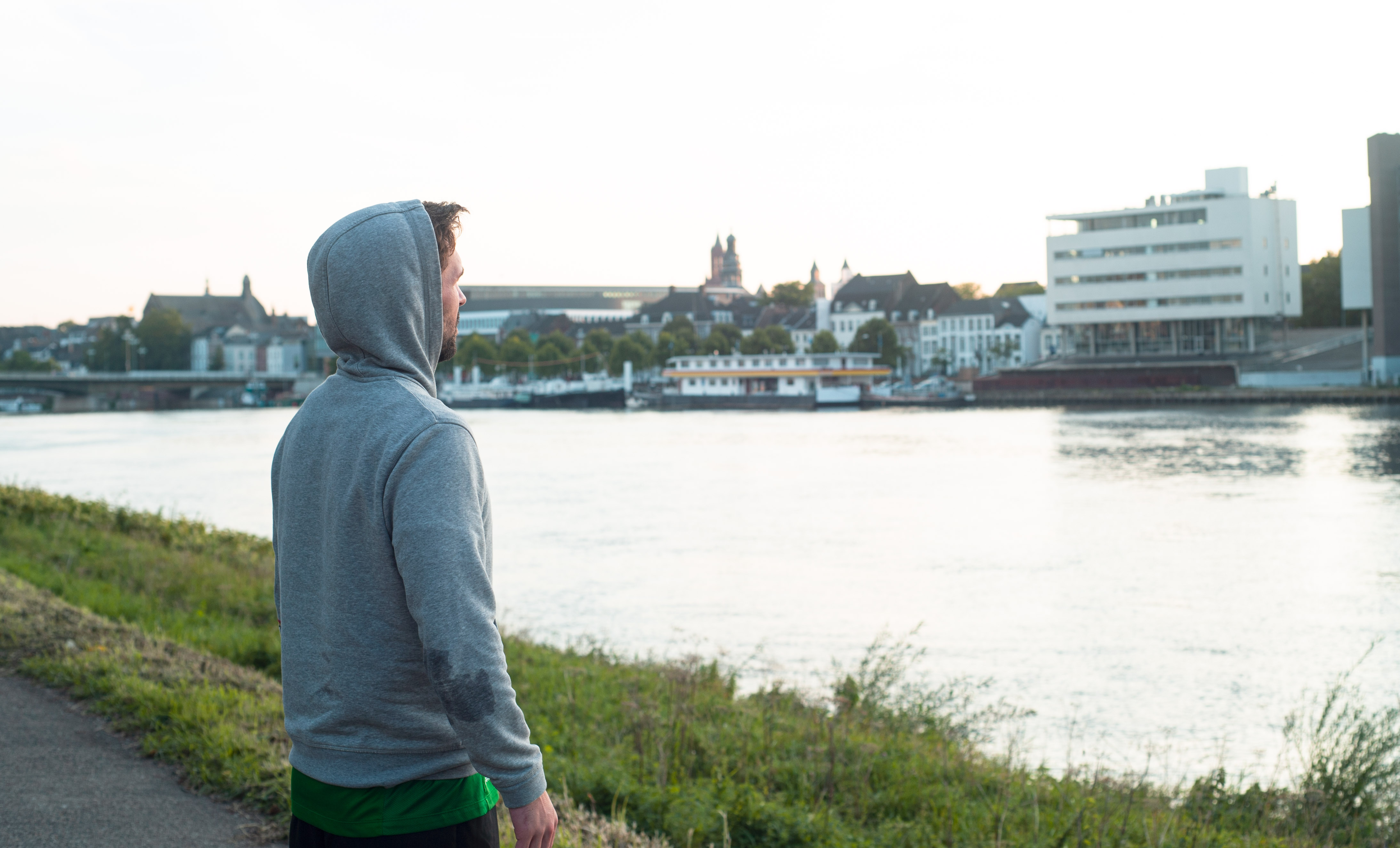 Young man looking out over the river Meuse