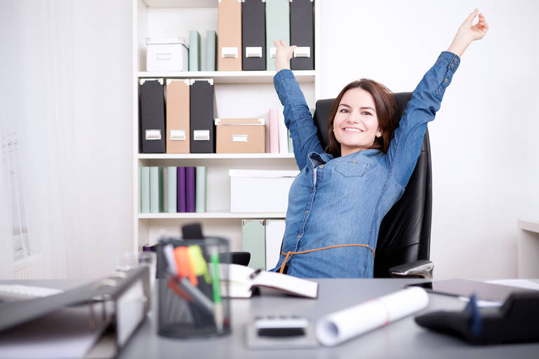 Work Health and Career: woman in office stretching out