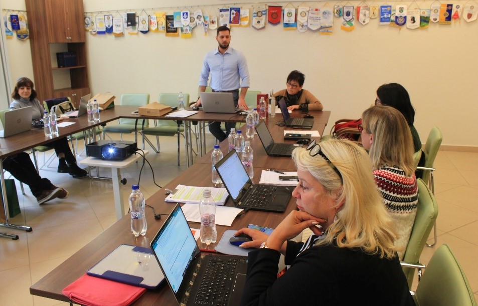 People sitting around a table with their laptops