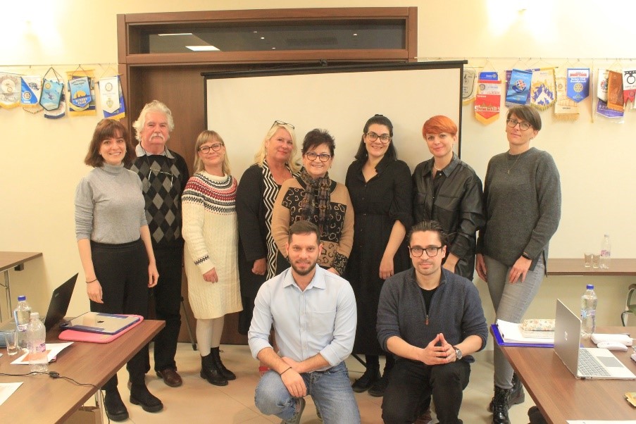 A group of people standing in a classroom