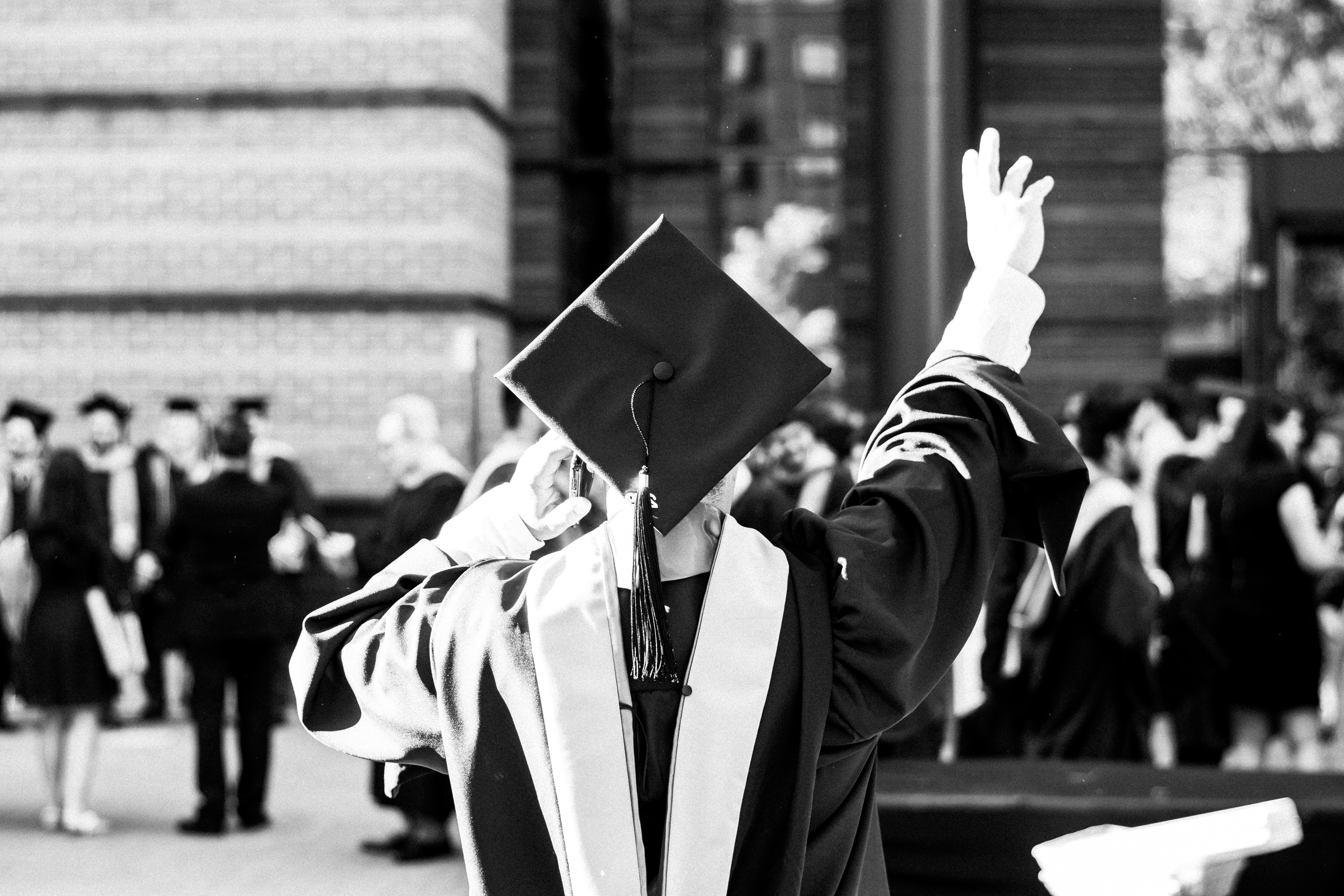 greyscale-photography-of-person-wearing-academic-dress 