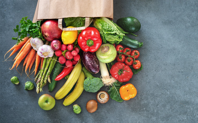 A grocers' bag full of vegetables