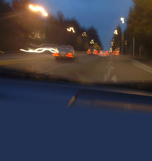 Vague view of traffic on road through windshield