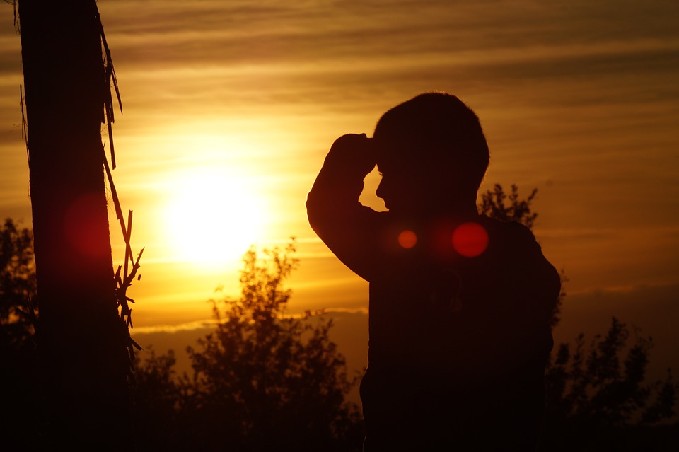 Picture of a child in front of a sunset