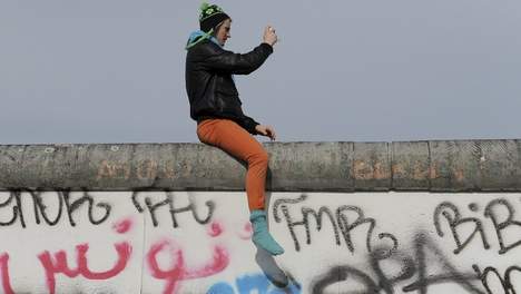 A picture of someone on the Berlin Wall.