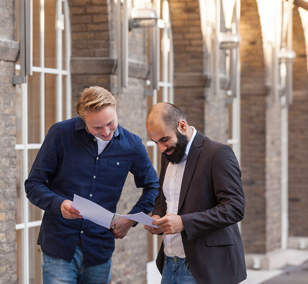 Two employees looking at papers