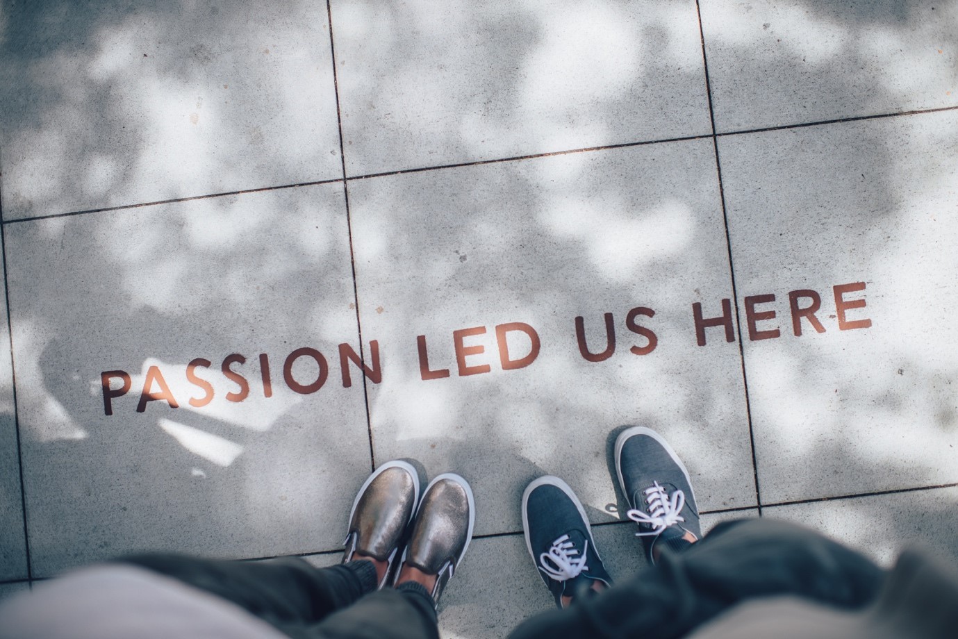 The text 'Passion Led Us Here' on the walkway