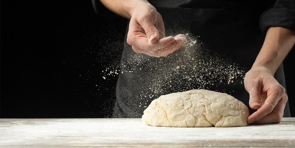 Man kneading bread dough