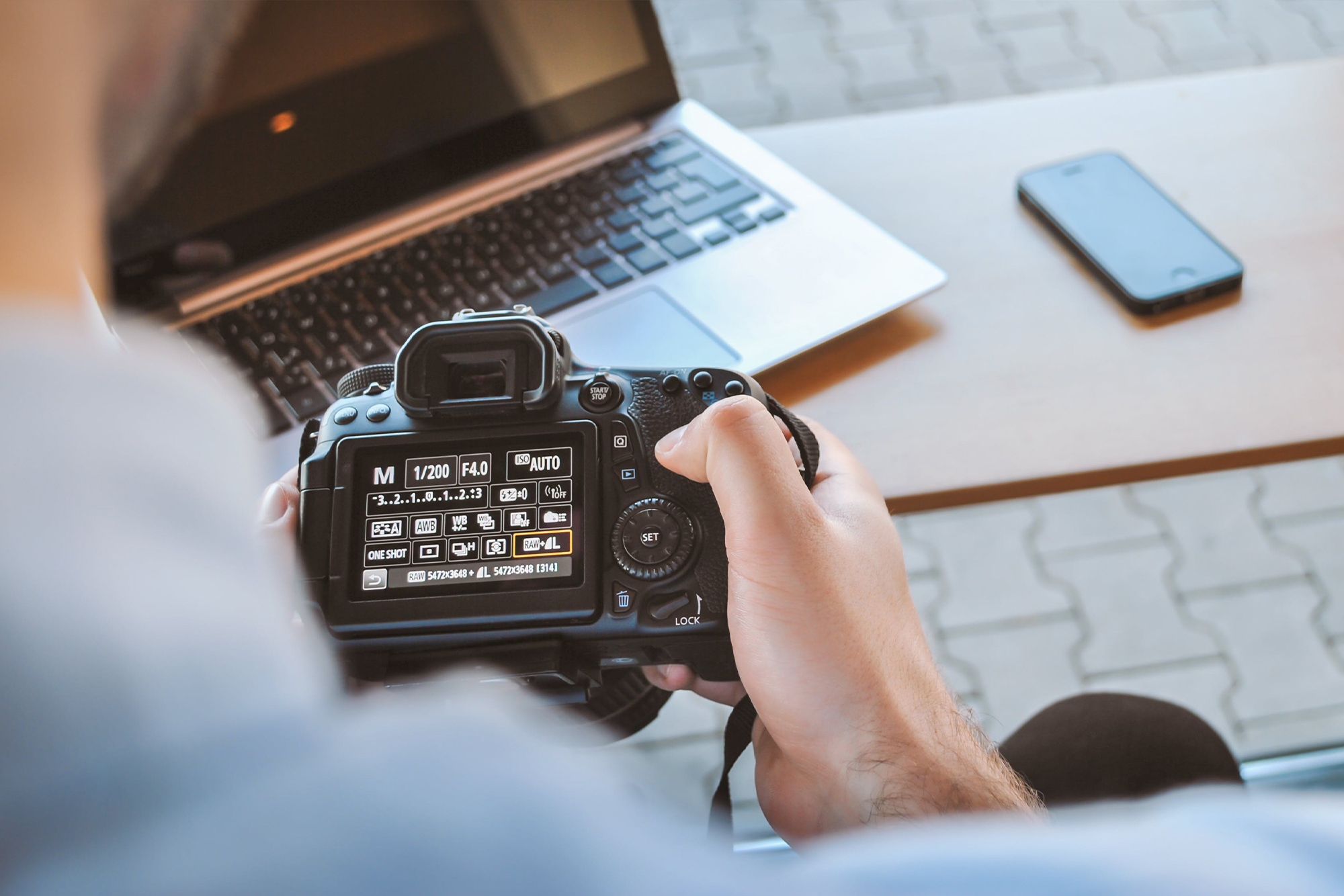 person holding a DSLR camera