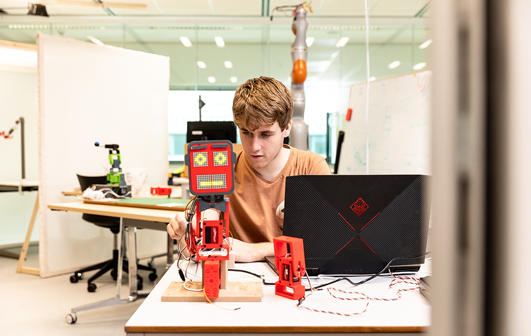 Student programming a robot