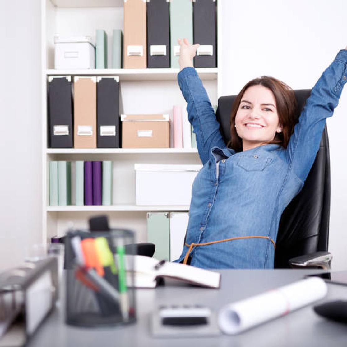 Work Health and Career: woman in office stretching out