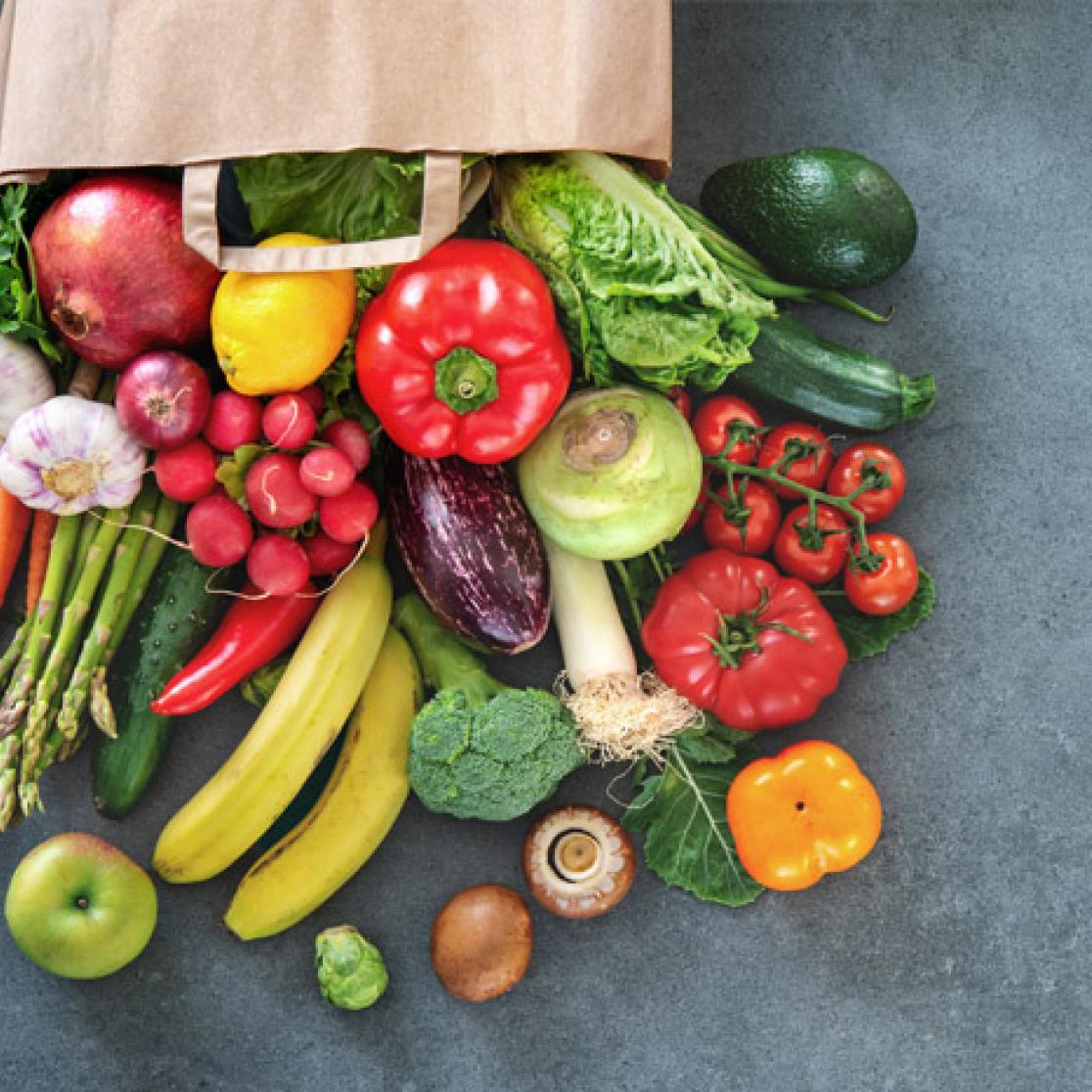 A grocers' bag full of vegetables