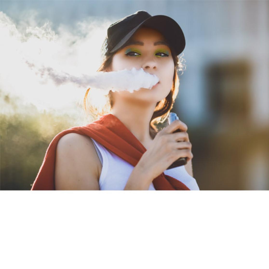 Young woman smoking an e-cigarette