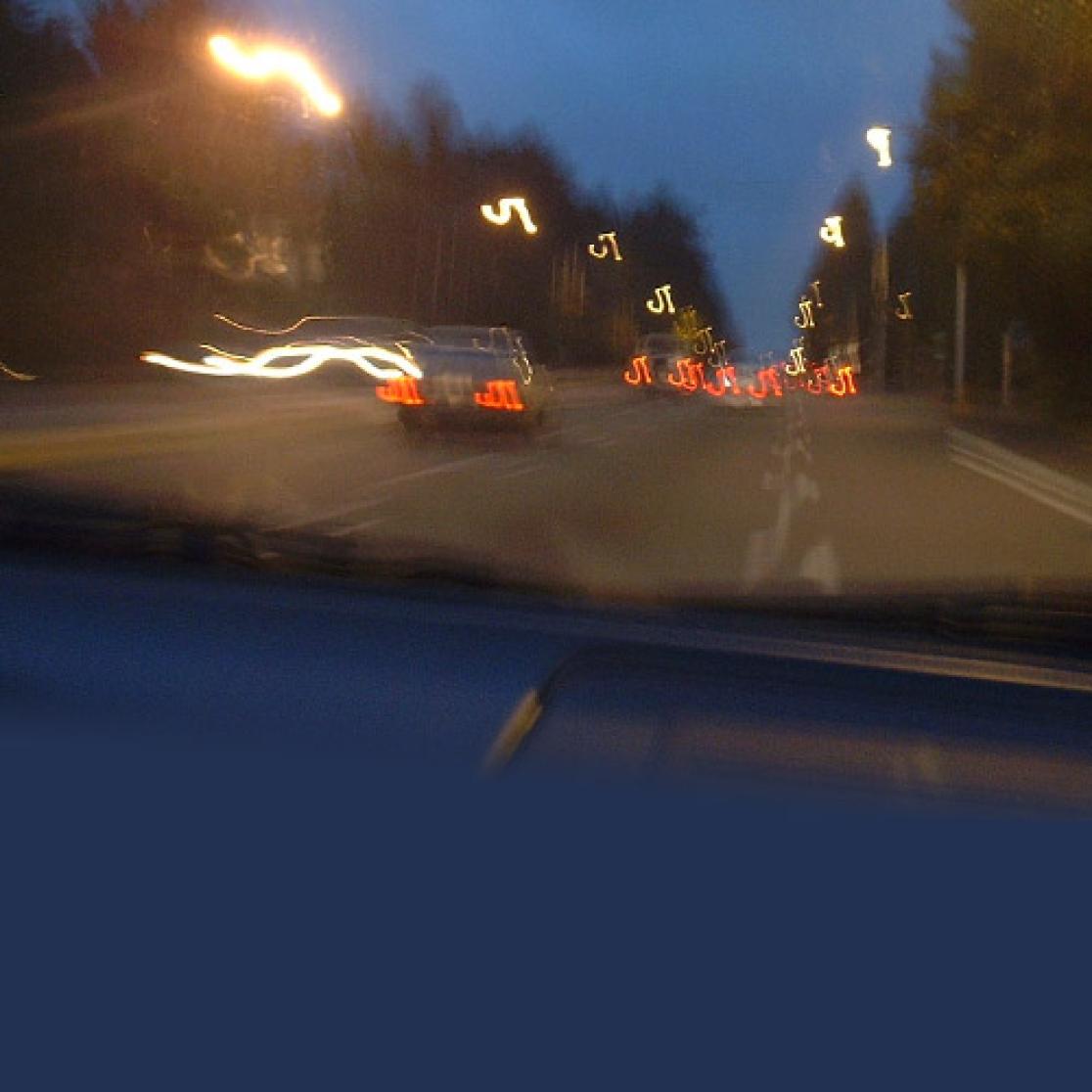 Vague view of traffic on road through windshield