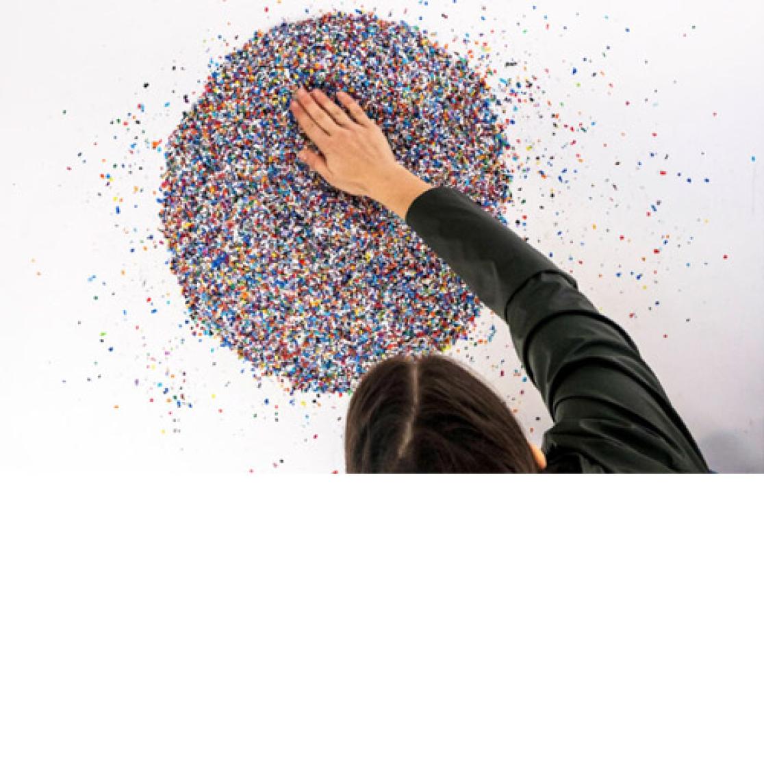 Young woman examining plastic granules