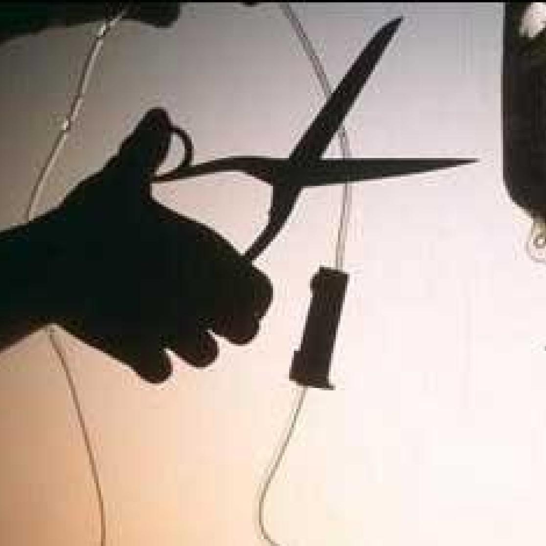 A picture of someone cutting through a feeding tube of a patient, performing euthanasia.