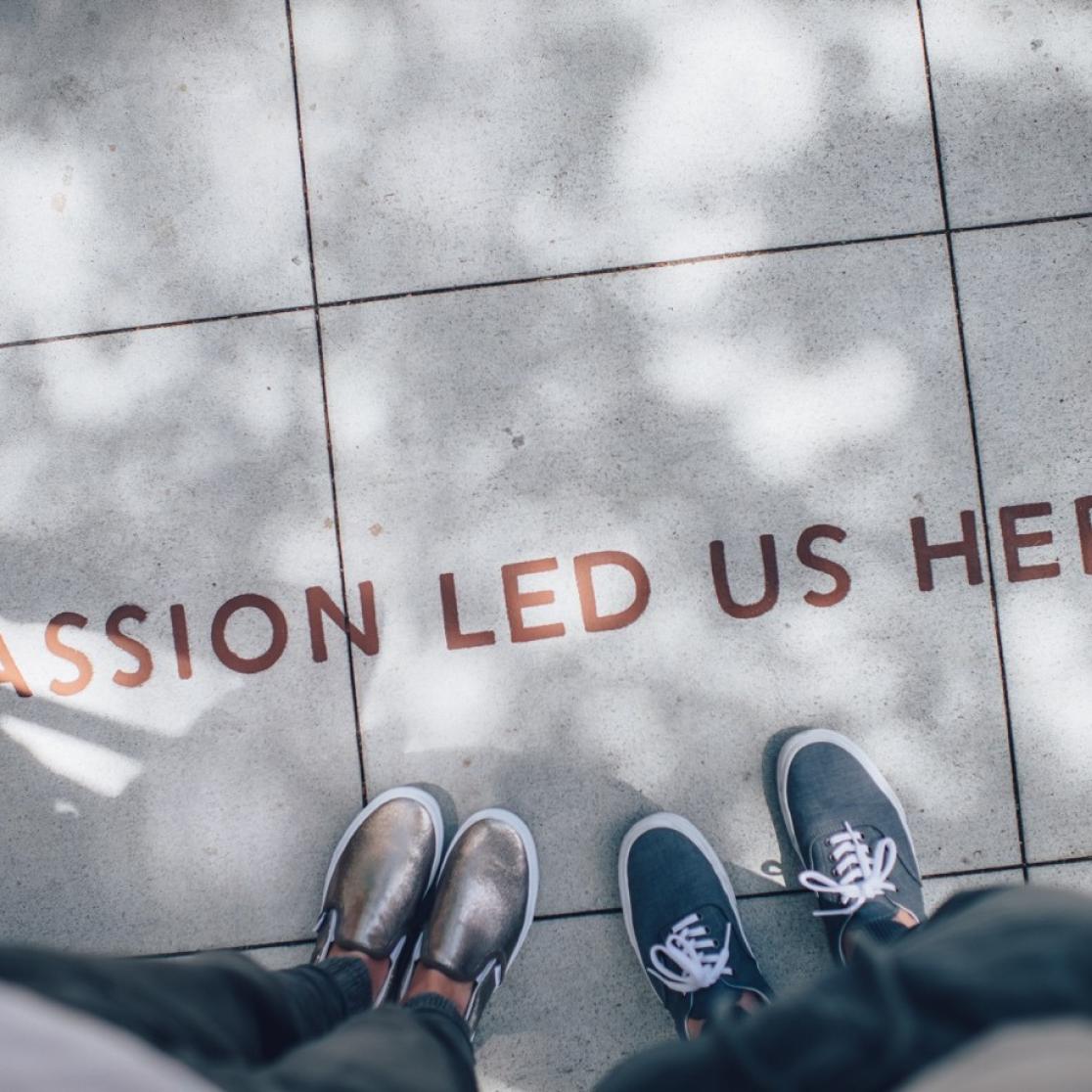 The text 'Passion Led Us Here' on the walkway