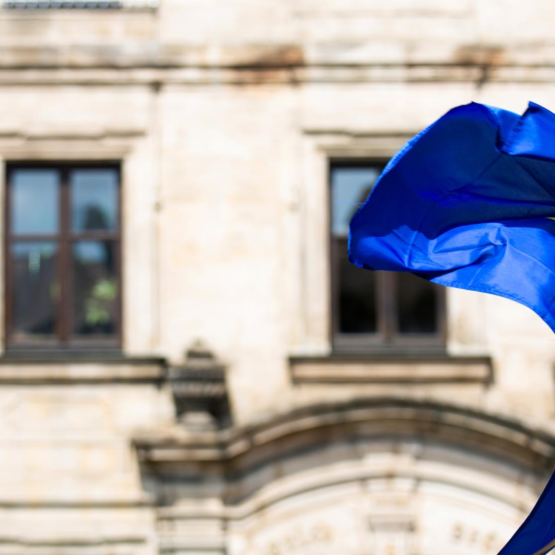 European Flag waving in the wind in front of a building