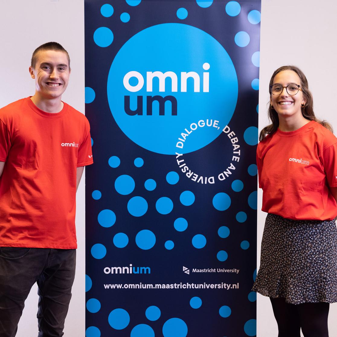 Two OmniUM volunteers standing next to a sidewinder