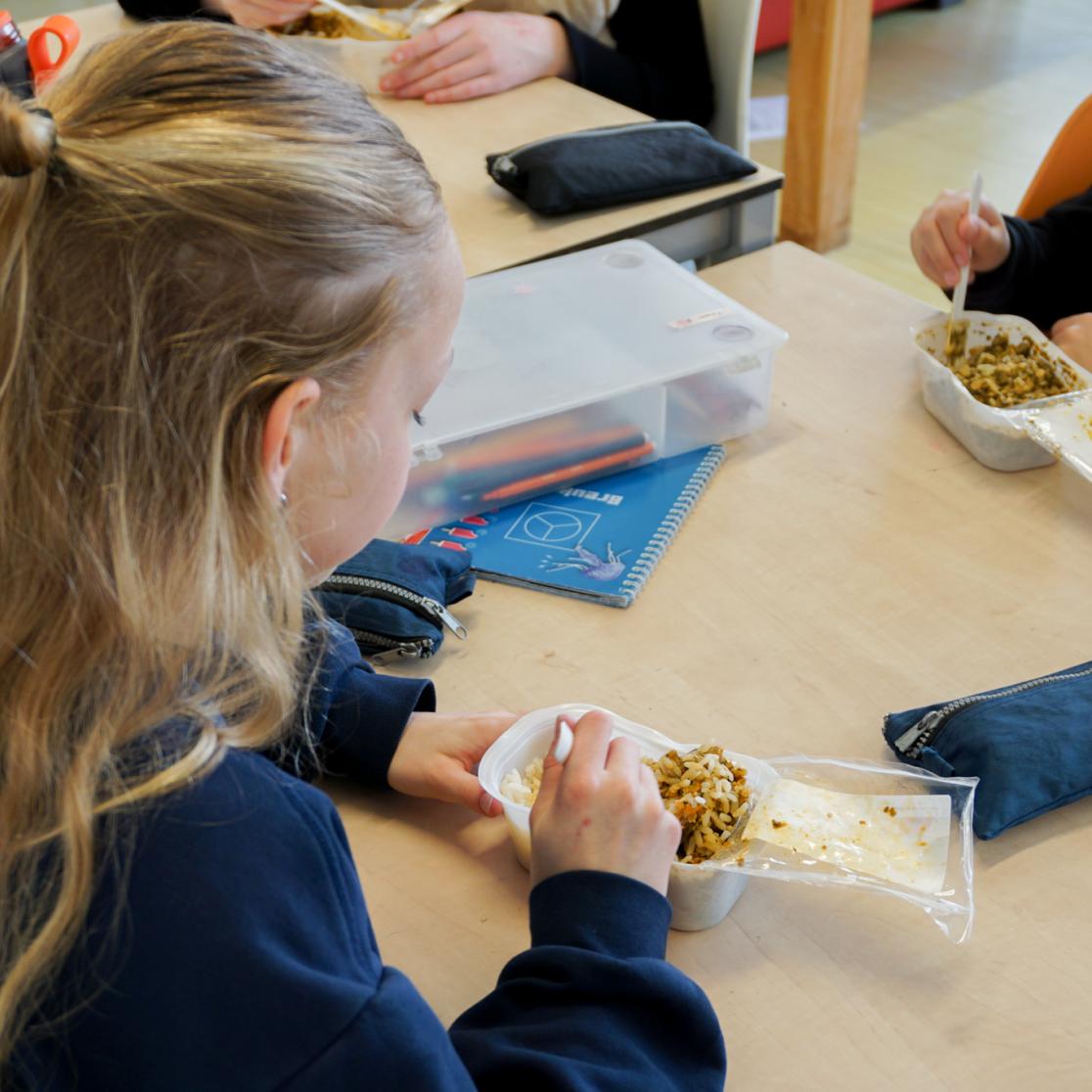 Young girl eating schoollunch
