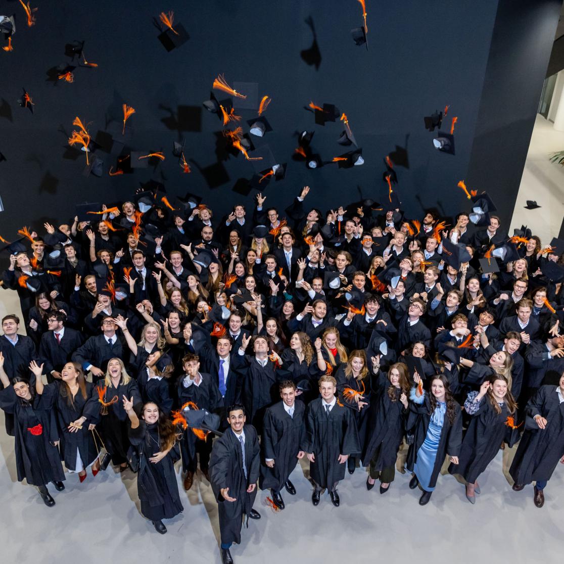 SBE graduates throwing their caps in the air
