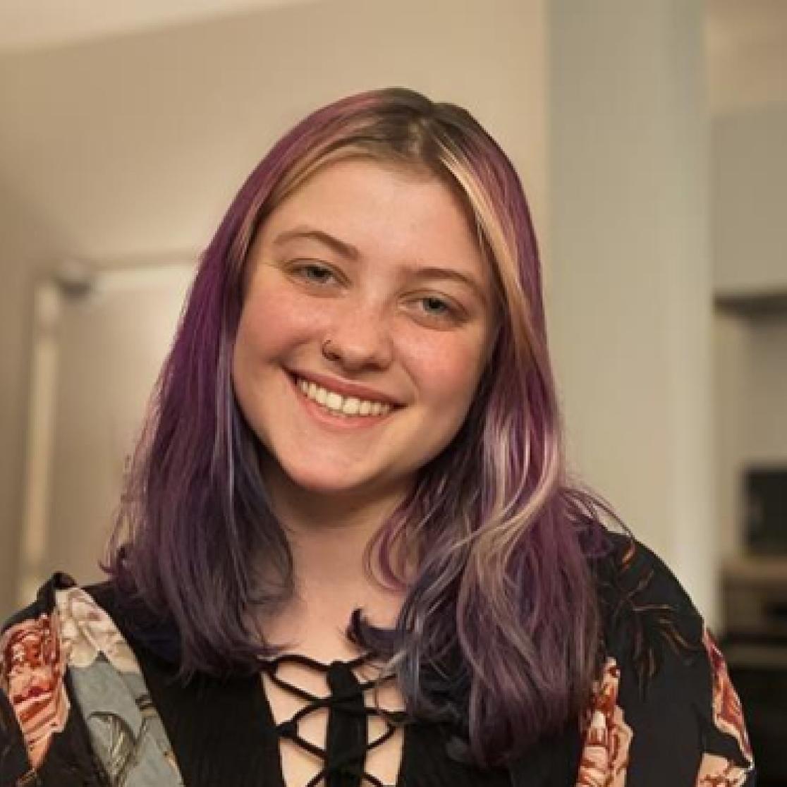 Girl with purple hair smiling