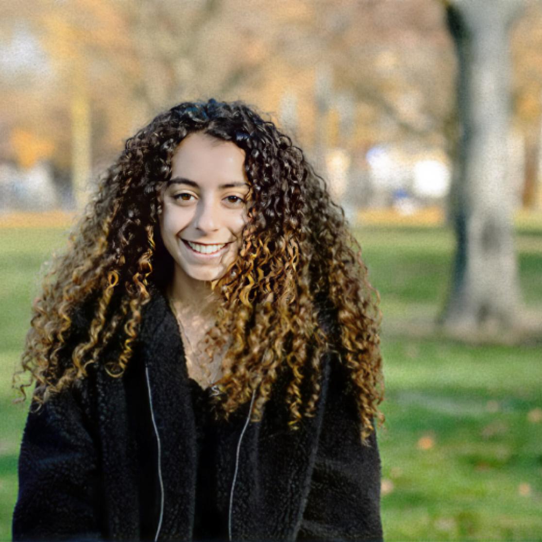 Smiling lady with big curly hair outside