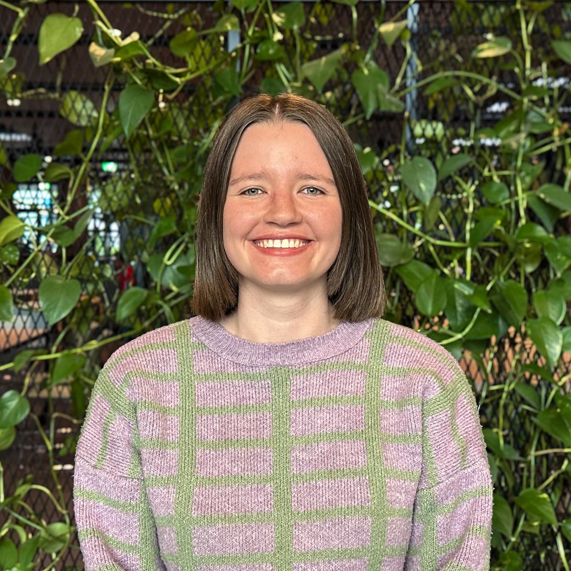 Woman standing in front of plants background