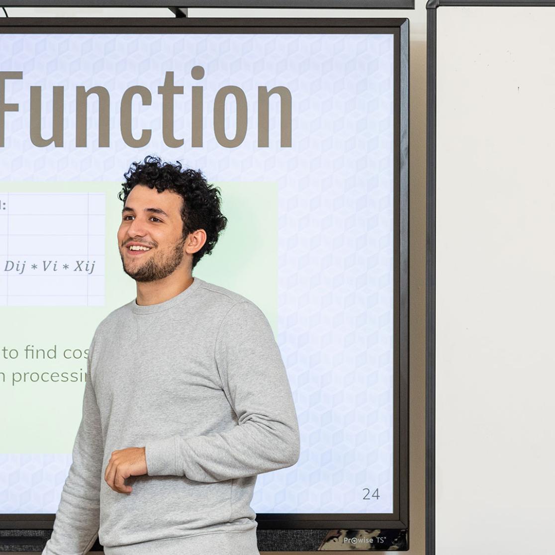 A student giving a presentation about objective function