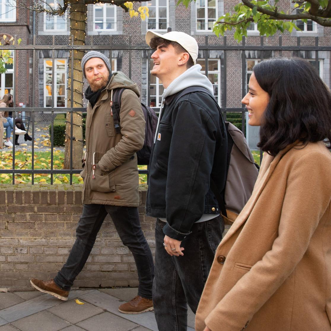 Students walking and chatting, smiling