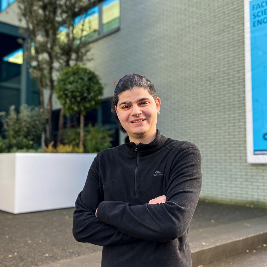 Student ambassador standing in front of faculty building