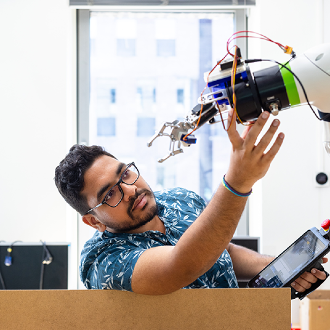 Student working with mechanical arm