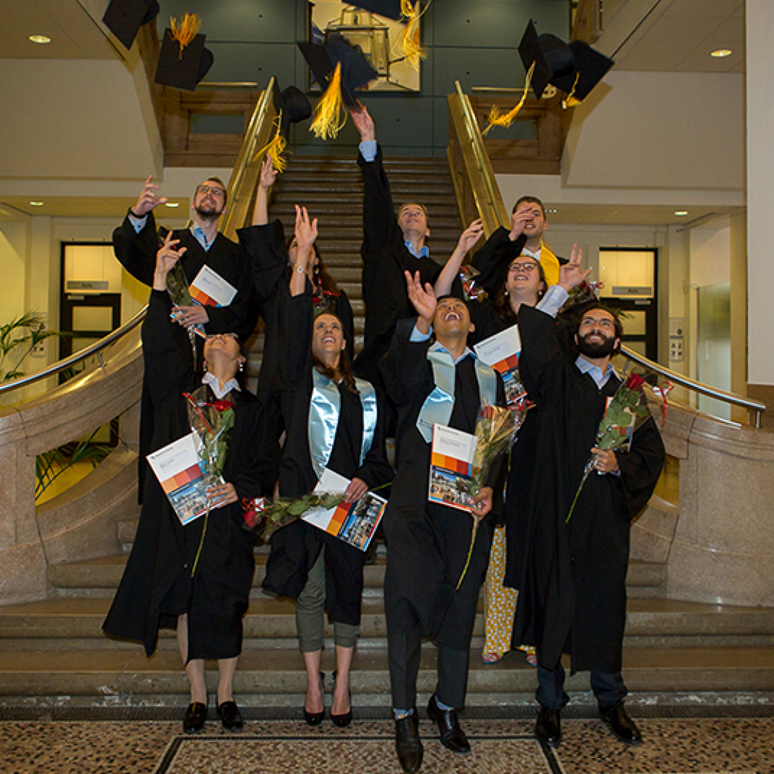 Graduates throwing caps in the air