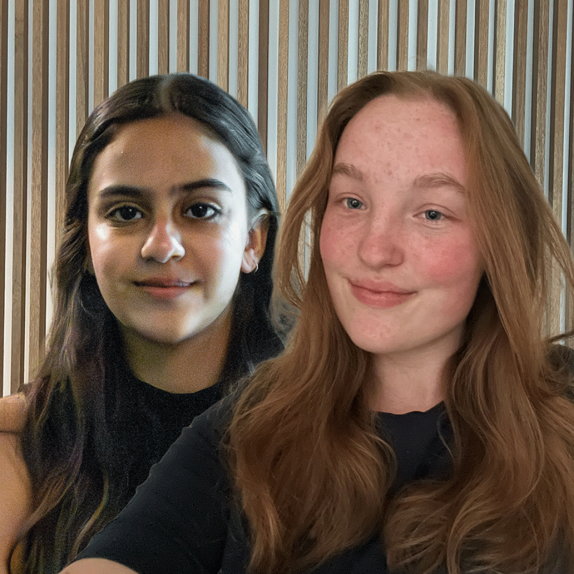 Two female students in front of wood panel wall