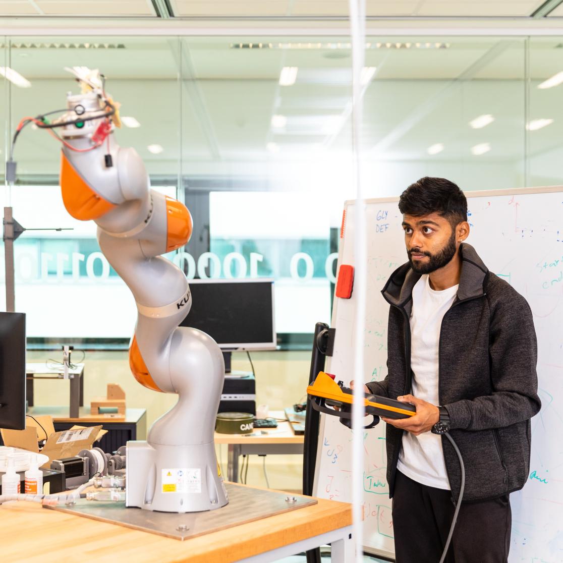 Guy working with robot arm