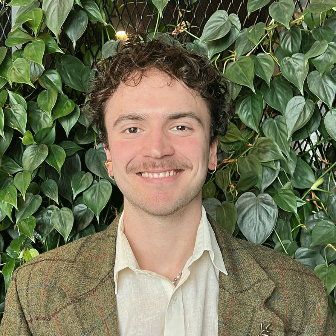 Guy standing in front of plants