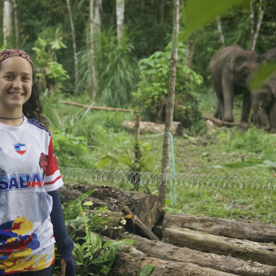 Portrait Natasha Lawrie next to Bornean elephants