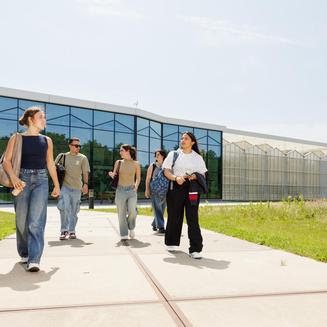 Students walking in front of the research greenhouse in Venlo