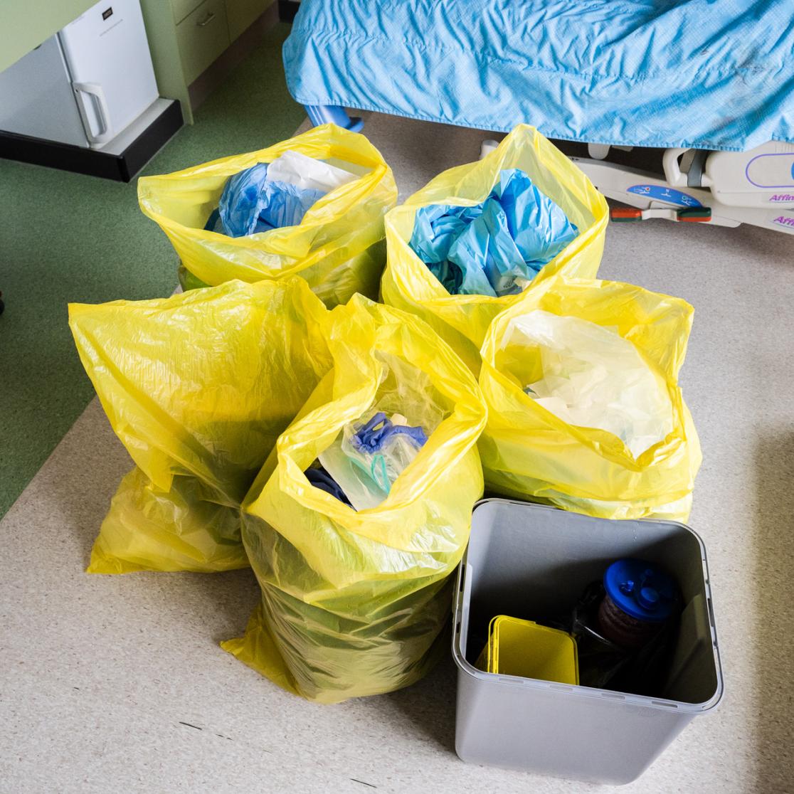 plastic waste stacked in yellow plastic bags