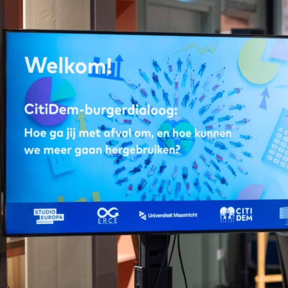 A tv screen that shows a presentation about the ERCE event