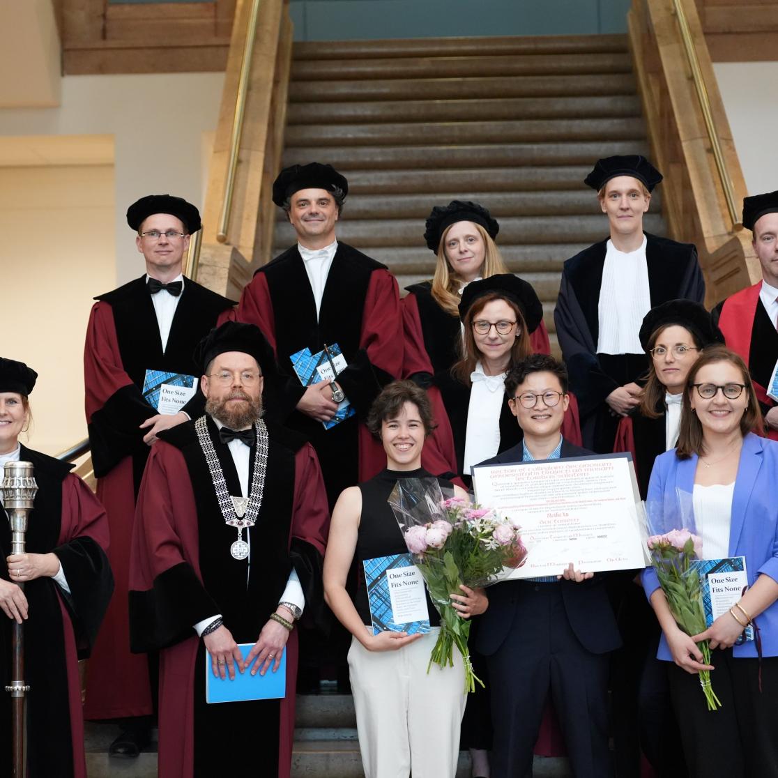 academics posing in front of stairs with candidate
