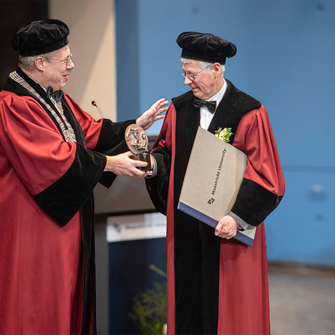 Professor handing over lecture to professor