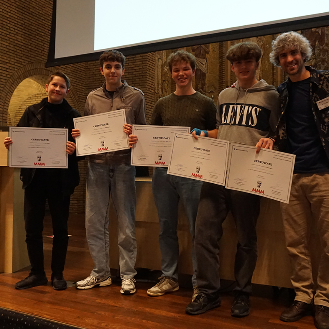 Students posing with cheque after winning contest
