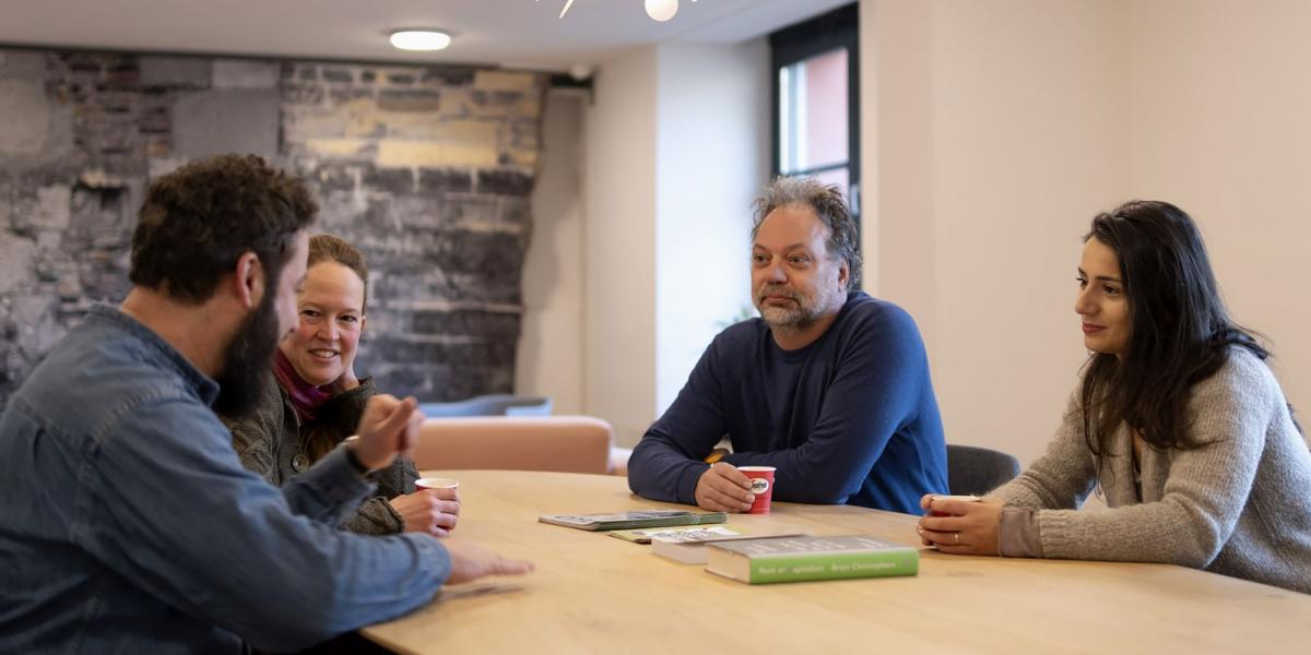 Local meeting with 4 participants around a table