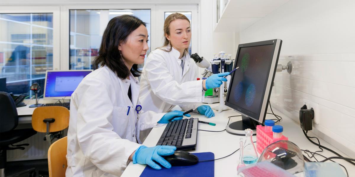Two researchers looking at a computer