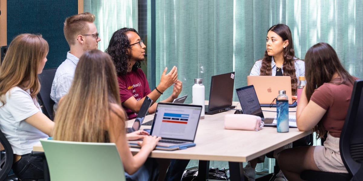 Group of students having a discussion in a classroom