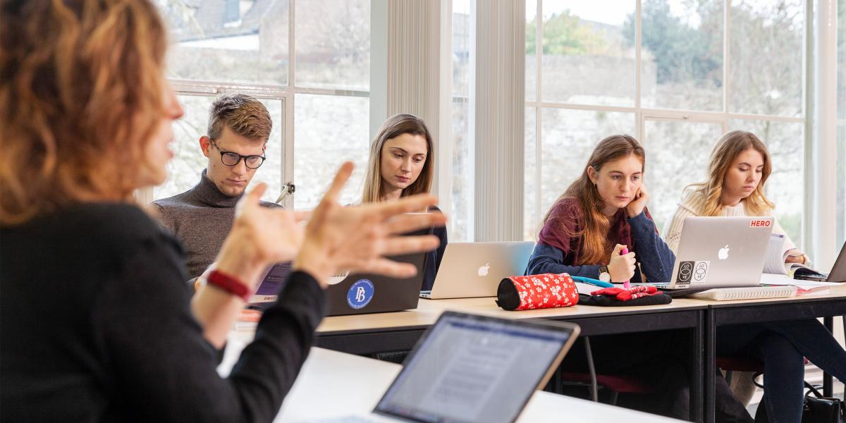 Students looking at their laptop in class