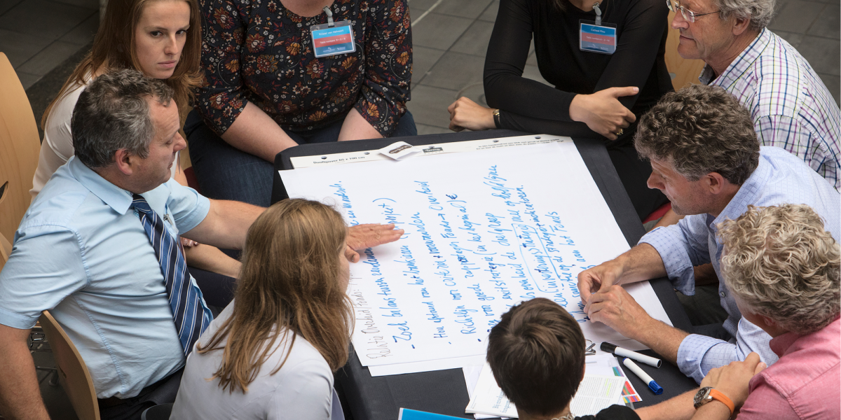 UM Academy: professionals working together around big piece of paper