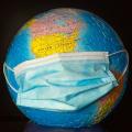Master global health represented by a globe with a surgical mouth mask