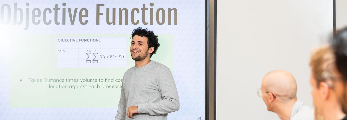 A student giving a presentation about objective function